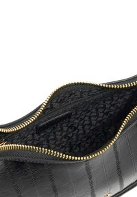 Black zippered bag made of textured faux leather, featuring a gold zipper and a patterned black interior lining with a small zip pocket.