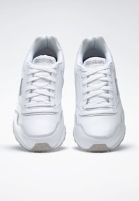 Weiße Leder-Sneaker mit glatter Oberfläche, runder Zehenpartie und flachen Schnürsenkeln. Verfügt über ein dezentes Reebok-Logo und eine strukturierte Gummisohle.