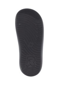 Semelle intérieure en caoutchouc noir avec surface texturée et motif de semelle ondulée. Présente un logo surélevé et une petite indentation circulaire.
