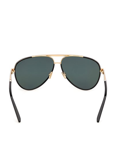 Lunettes de soleil de style aviateur avec verres vert foncé, monture en métal doré, branches noires et plaquettes de nez ajustables.
