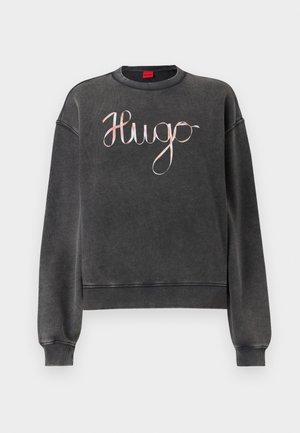 Grå sweatshirt med avslappnad passform, som har rund halsringning och ribbade muddar. Den har en blank, kursiv "Hugo"-logotyp i pastellfärger framtill.
