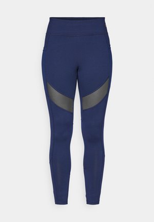 Leggings azul-marinho feitos de material elástico, com painéis de destaque cinzas e uma cintura alta. Projetados para uso ativo.