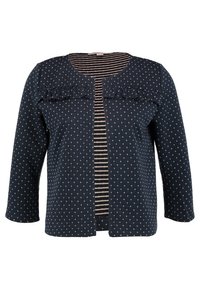Cardigan bleu marine à pois blancs, avec des volants au niveau de l'encolure et un intérieur rayé. Manches trois-quarts.