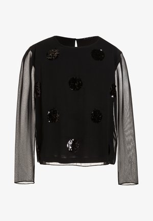 Haut noir à manches longues en tissu transparent, avec des embellissements en sequins noirs ronds. Encolure ronde simple et détail en trou de serrure au dos.