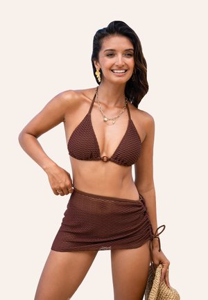 Brown crochet bikini top with halter straps and ring accent; matching brown wrap skirt with gathered detailing. Smooth texture.