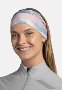 Cinta para la cabeza Buff ligera en colores pastel con patrones abstractos. El material es elástico y transpirable, adecuado para actividades al aire libre.