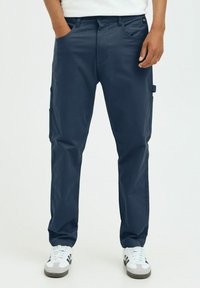 Navy blue cargo pants with front pockets, side cargo pockets, and belt loops. Made of smooth fabric with a straight-leg cut.