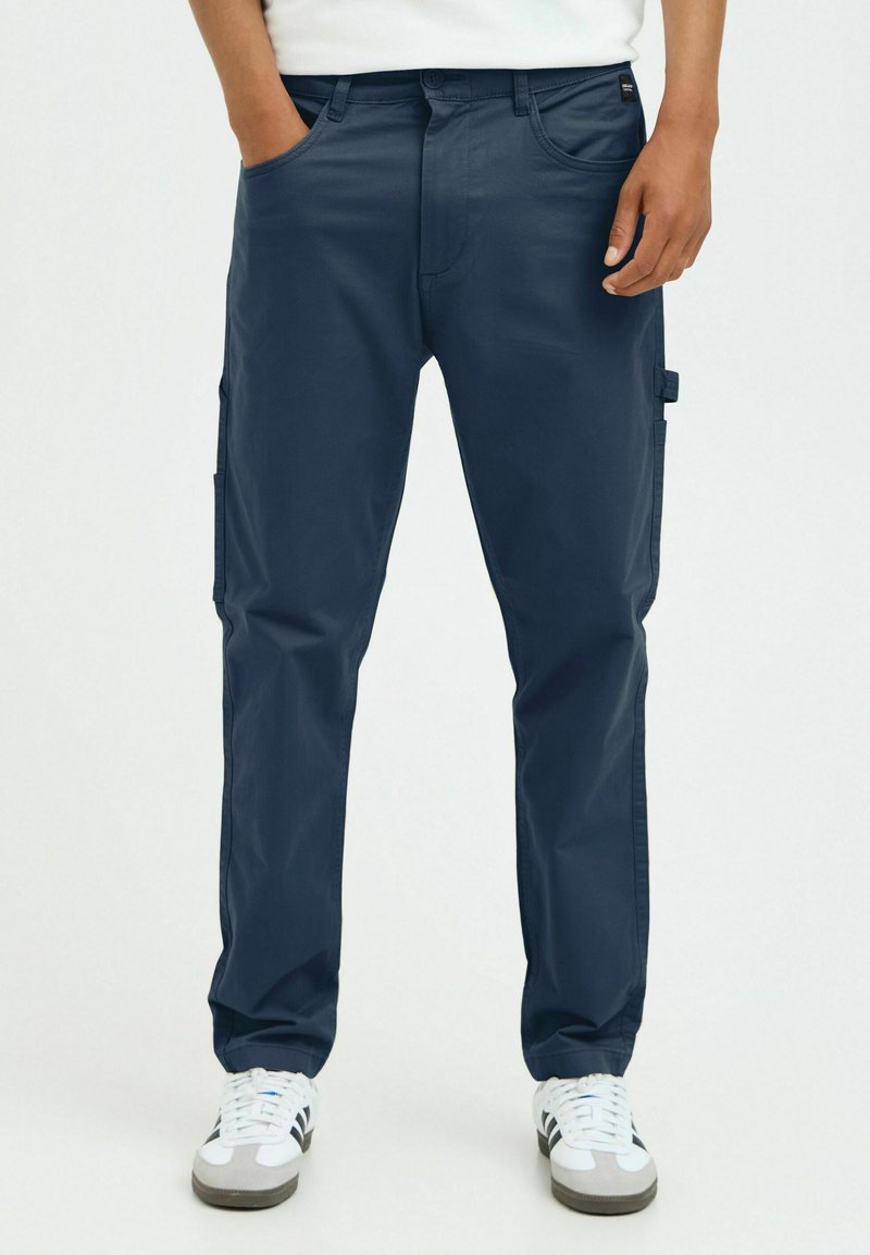 Navy blue cargo pants with front pockets, side cargo pockets, and belt loops. Made of smooth fabric with a straight-leg cut.
