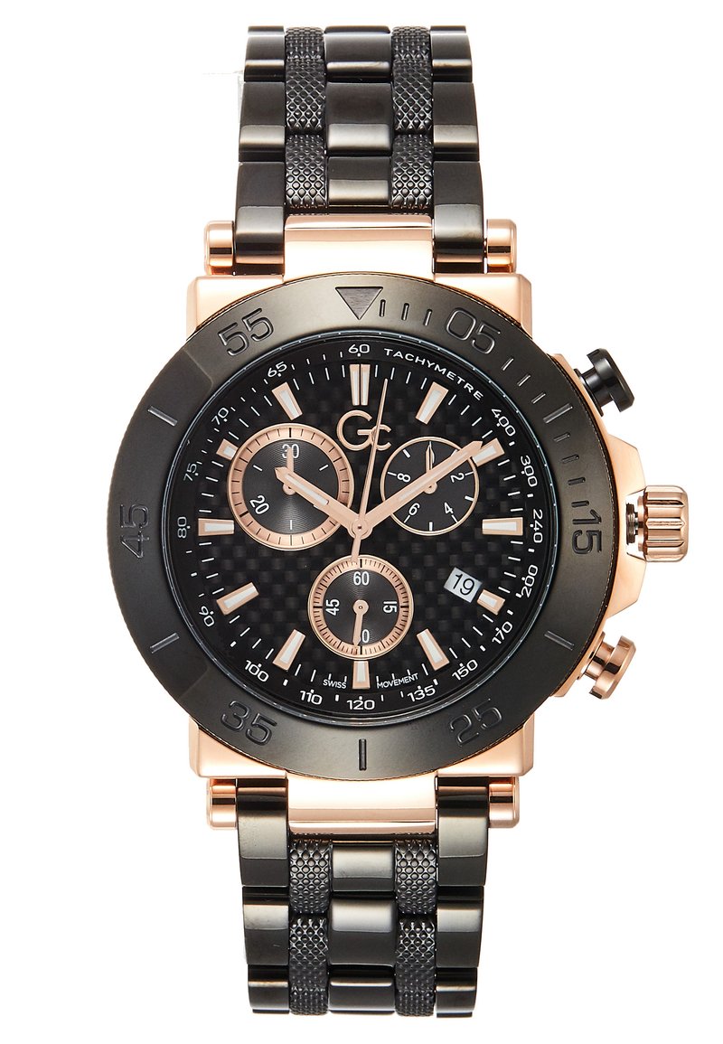 Black and rose gold chronograph watch with a textured strap, carbon fiber dial, three subdials, and a date display at 4 o'clock.