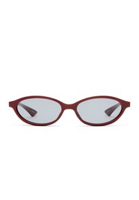 Red sunglasses with an oval shape, gray lenses, and a smooth plastic frame. Temples taper inward towards the hinge.