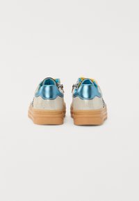Silver and blue sneakers with a scalloped design, textured metallic upper, soft interior lining, and gum rubber sole.