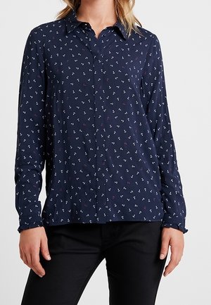 Navy blue button-up shirt made of lightweight fabric, featuring a repeating anchor pattern in white and purple. Collared with long sleeves.