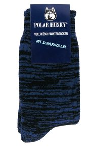 Schwarze und blaue gemusterte Wintersocken aus plüschigem Material, mit dicker Textur und weichem Gefühl, versehen mit einem Etikett mit der Aufschrift "Polar Husky".