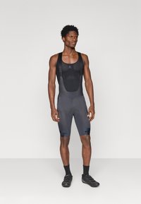 Mustad musta värvi jalgrattasõiduks mõeldud lühikesed püksid, mis on valmistatud hingavast kangast, sisseehitatud polsterdatud istme, õlavööd ja jalgadel "ENJURA" brändingu.