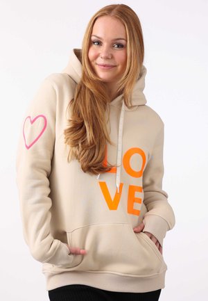 Beige hoodie with large orange "LOVE" print on the front, pink heart detail on the left sleeve, drawstring hood, and front pockets.