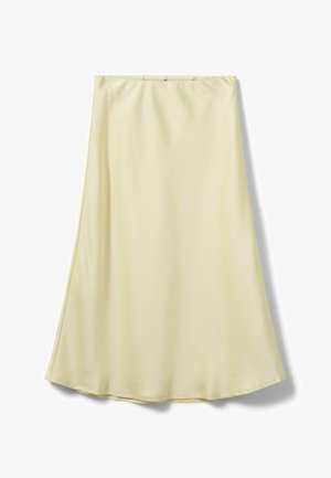 Jupe trapèze crème longueur genoux, en tissu lisse avec des coutures discrètes le long de l'ourlet, présentée sur un fond blanc.