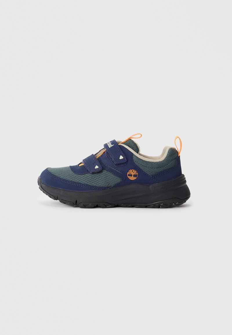 Navy blue and green toddler sneaker with black sole, two velcro straps, orange logo, and orange pull tabs on grey background.