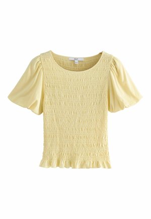 Geltona palaidinė su raukšlėta tekstūra ir trumpomis pūstomis rankovėmis. Apvali iškirptė ir raukiniais puoštas apatinis kraštas. Minkštas audinio paviršius.