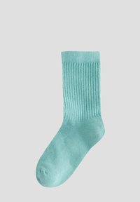 Chaussette côtelée vert menthe avec une texture douce, un modèle mi-mollet et un orteil renforcé, conçue pour le confort et la durabilité.