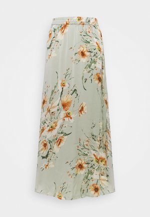Jupe longue vert clair avec imprimé floral orange et blanc et taille élastique, présentée sur un fond uni.