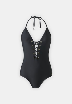Musta uimapuku, jossa on syvä V-aukko, nauhakiinnitys edessä ja kultaiset niitit. Säädettävät halterneck-nauhat, sileä tekstuuri ja istuva siluetti.