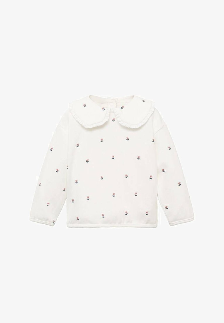 Haut blanc à manches longues avec un col à volants, parsemé de petites broderies florales en rose et marine. Tissu doux, coupe décontractée.