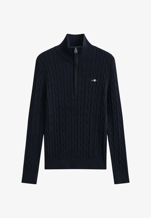 Jersey azul marino de punto trenzado con mangas largas, medio cremallera, cuello alto y pequeño logo bordado en el pecho izquierdo.