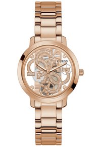 Orologio color oro rosa con un quadrante trasparente che presenta le iniziali del marchio intrecciate, accenti metallici lucidi e un bracciale di metallo a maglie.