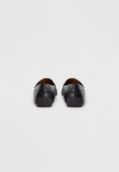 Pantofi negri din piele cu un finisaj neted, talpă din cauciuc cu un model de profil și un design minimalist. Fără elemente decorative vizibile.