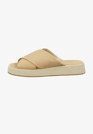 Tan leather slide sandal with cross-band design, a cushioned cream sole, and textured outsole for grip. Minimalist style with soft finish.