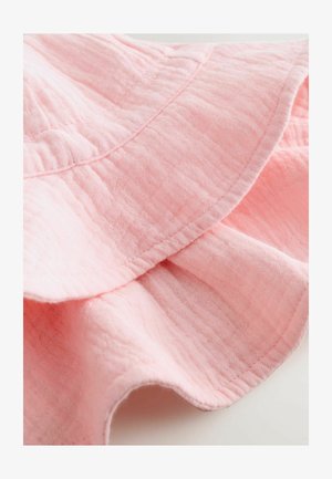 Heledad roosa puuvillakangas, millel on volangserv ja tekstureeritud pind, peenete toonivarjunditega ning pehme ja kergelt kaaluga välimus.