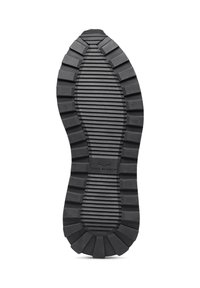 Black rubber shoe sole with pronounced grooves and ridges, featuring a smooth, rounded edge and a central logo detailing.