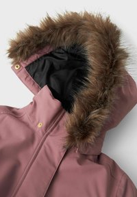 Pink waterproof jacket with a brown faux fur-lined hood. Features snap closures and a black interior lining. Smooth fabric texture.