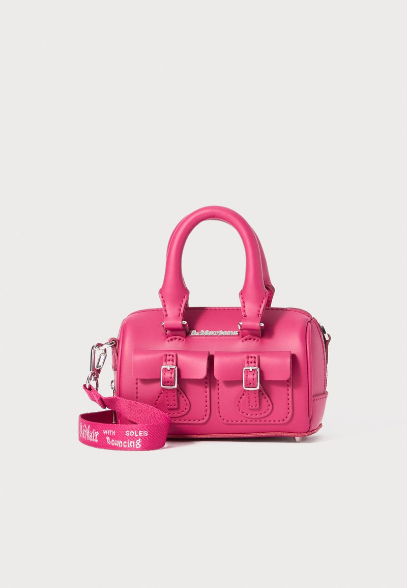 Pink handbag with textured leather, two front buckled pockets, short handles, and a detachable strap featuring "Bouncing" text.