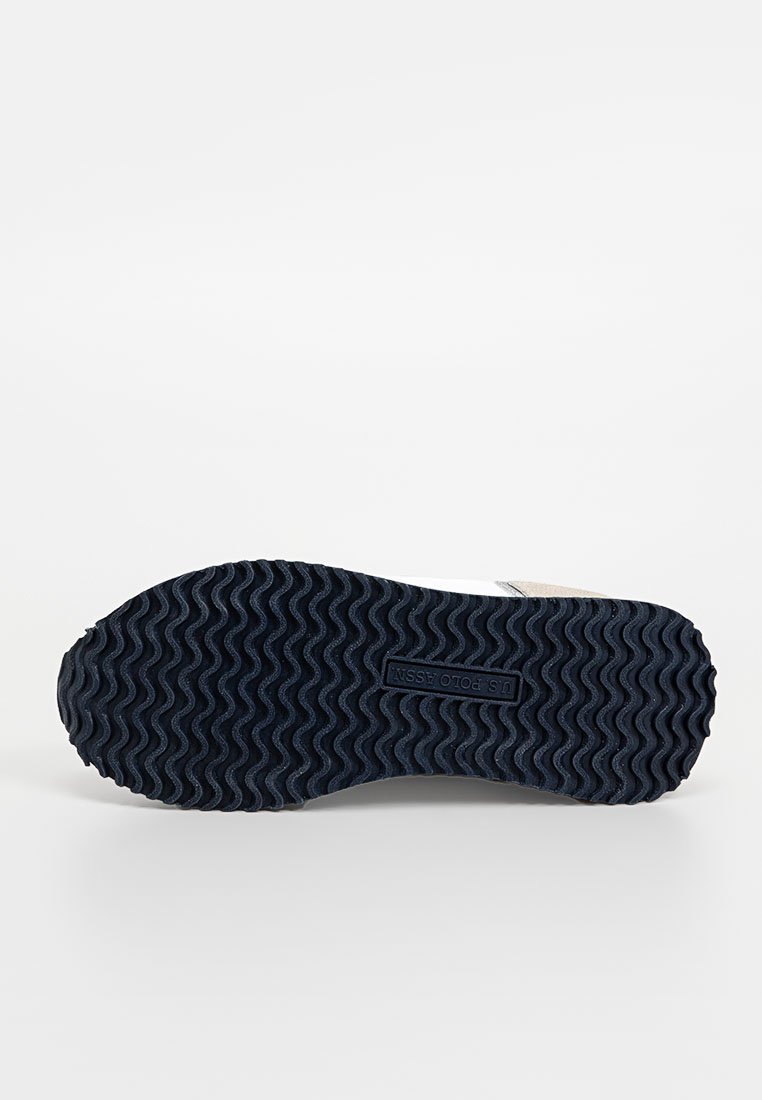 Suola della scarpa con un motivo testurizzato, predominantemente blu navy, con un logo del marchio impresso al centro. Materiale in gomma con design a onde.