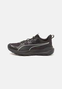 Black running shoe with mesh upper, padded collar, reflective accents, and textured rubber sole, featuring a curved design for improved stability.