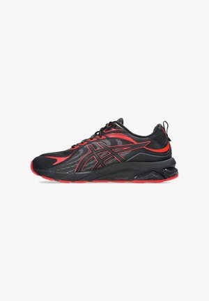 Black and red athletic shoes featuring a mesh upper, textured accents, and a cushioned sole with a distinct pattern. Slender design.