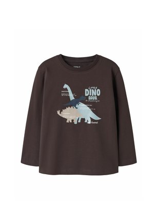 Chemise à manches longues marron foncé avec des illustrations de dinosaures bleues et beiges et le texte "Little Dinosaur Archaeologist Dino Expert" sur le devant.