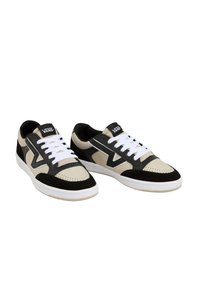 Vans sneakers featuring a mix of black, beige, and white materials, with a textured suede finish, perforated toe cap, and white laces.