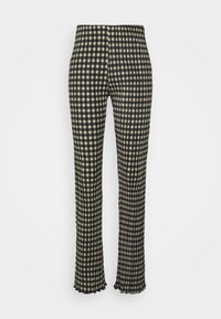 Pantalon à carreaux noirs et beiges avec une ceinture élastique, des jambes évasées et un tissu texturé. L'ourlet présente un bord froncé.