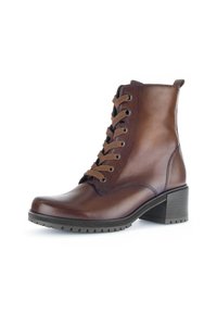 Botte cheville en cuir marron avec un bout arrondi, des lacets marron, un talon texturé et une légère plateforme. Présente des coutures et des oeillets renforcés.