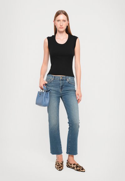 Black sleeveless top, blue jeans with a raw hem, leopard print flats, and a small blue handbag. All items feature modern, casual designs.