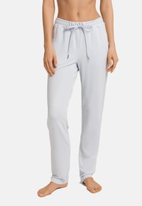 Ljusblå loungbyxor i ett mjukt och stretchigt tyg, med elastisk midjeband och justerbar dragsko. Har en slät textur och rak passform.