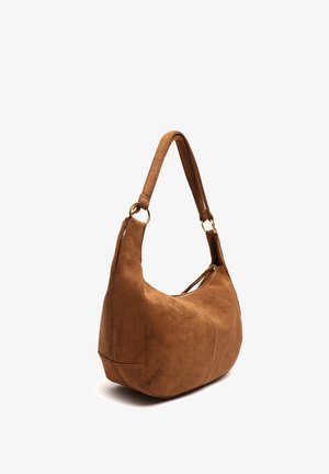 Brown suede shoulder bag with a wide strap attached by gold rings and a top zipper closure, shown at a slight angle.