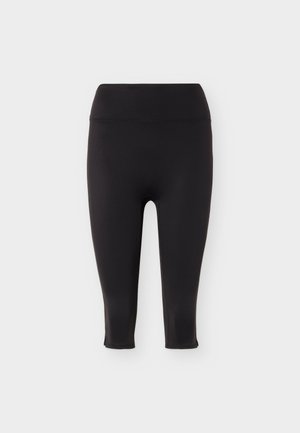 Μαύροι ψηλόμεσοι κολάν cropped με λεία ζώνη και διακριτικές σχισμές στον αστράγαλο, εμφανιζόμενοι σε απλό ανοιχτό φόντο.