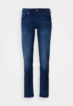 Jeans in denim blu scuro con design a gamba dritta, dotati di cinque tasche, chiusura con bottone e dettagli di lieve sbiadimento sulle cosce.