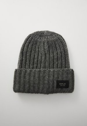 Gray knit beanie with a ribbed texture and a folded cuff. Features a black fabric label with white text on the front.