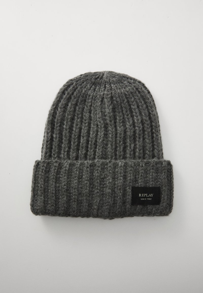 Gray knit beanie with a ribbed texture and a folded cuff. Features a black fabric label with white text on the front.