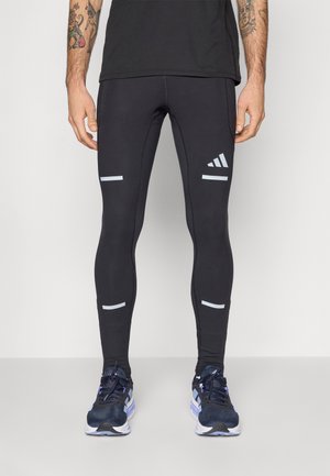 Zwarte sportleggings met reflecterende accenten. Heeft een slim fit ontwerp, rekbare stof en een logo op de onderste linkerbeen.