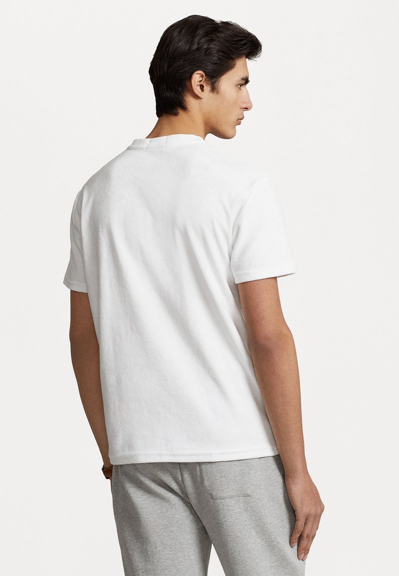 Witte katoenen t-shirt met korte mouwen en een ronde hals, gezien van achteren, met een gladde textuur en een eenvoudig ontwerp.